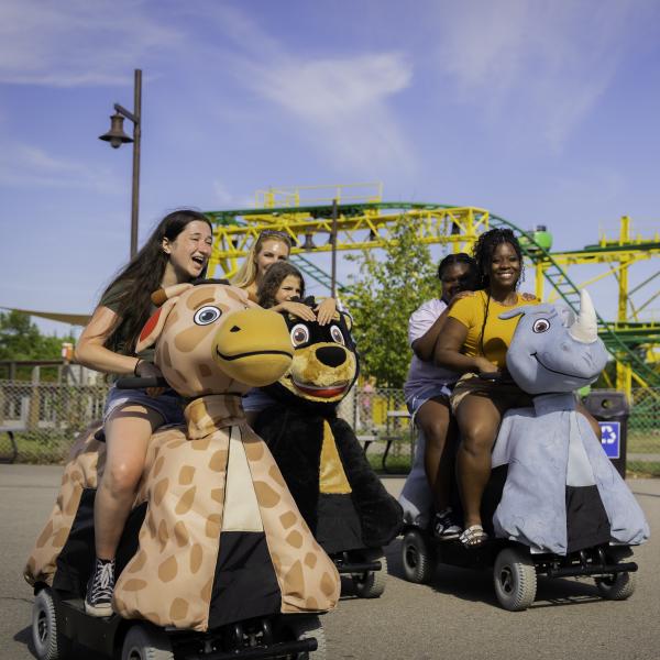 zoo guests on scooters that look like animals