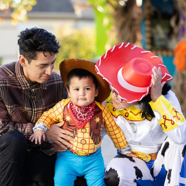 family at a Halloween event, smiling