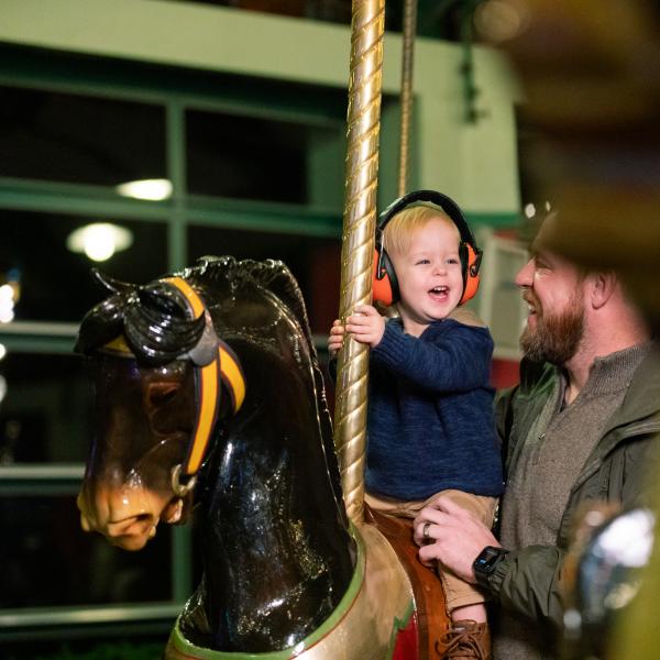 child on carousel
