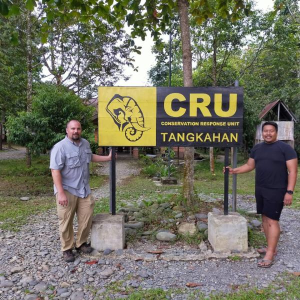 two men next to sign