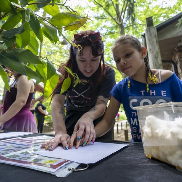 Zoo guest and educator working on project at the Columbus Zoo