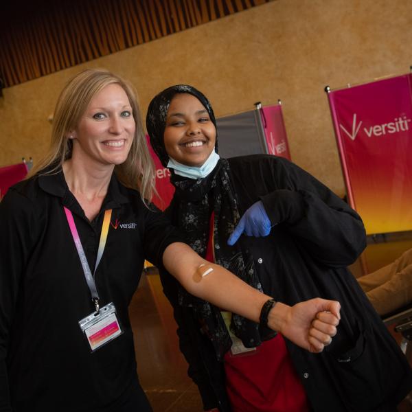 Blood drive participants smile at the camera