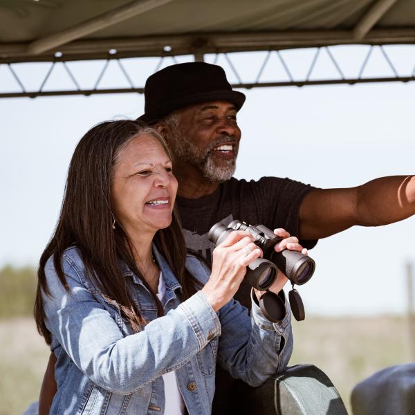 Two people birding at The Wilds