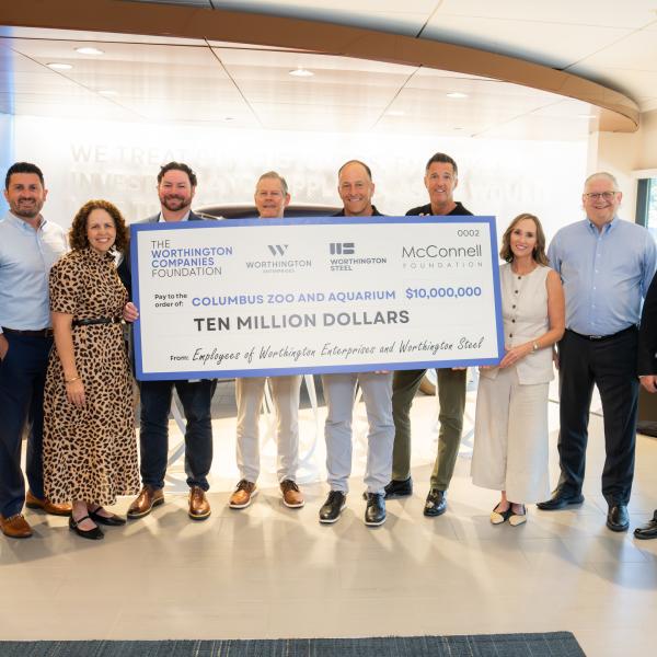 Team members holding $10 million check