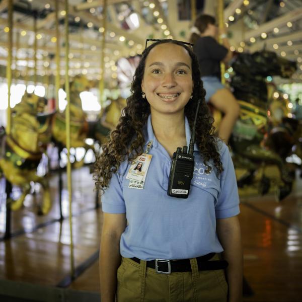 zoo employee smiling near carousel